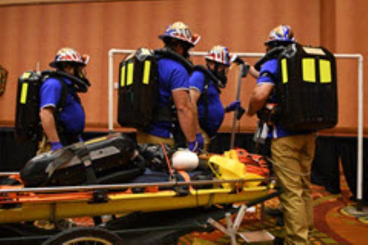 Photo of mine rescue class participants moving a volunteer on a stretcher