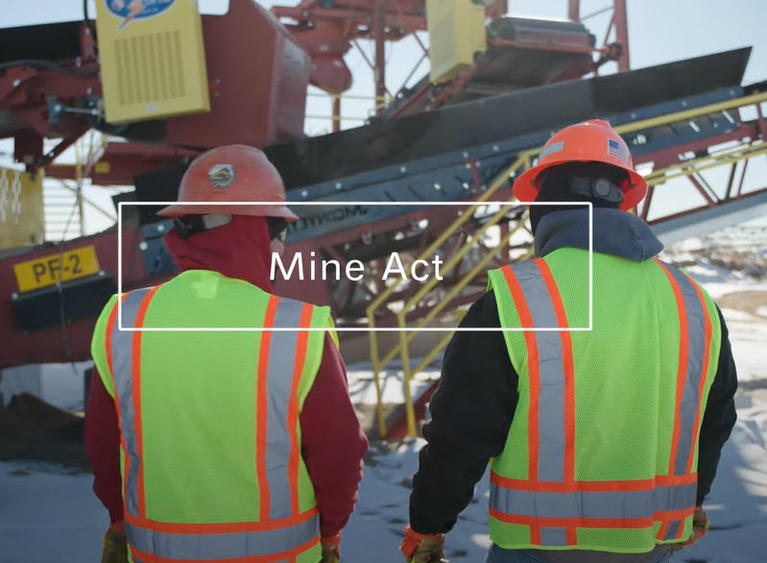 Screenshot of safety video showing two workers in safety gear