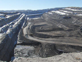 Photo of large surface coal mining operations showing benches and relative depth