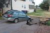 Photo of car in damaged driveway